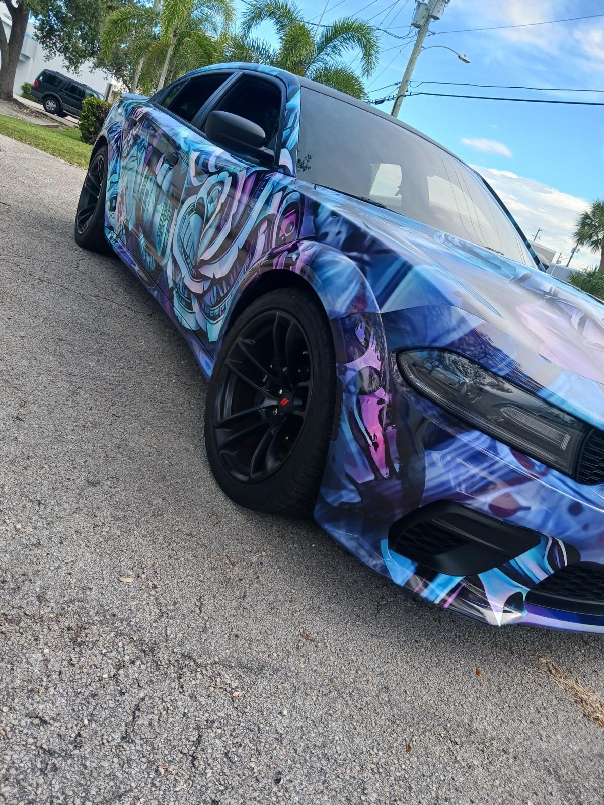 Custom graffiti-style full car wrap on Dodge Charger